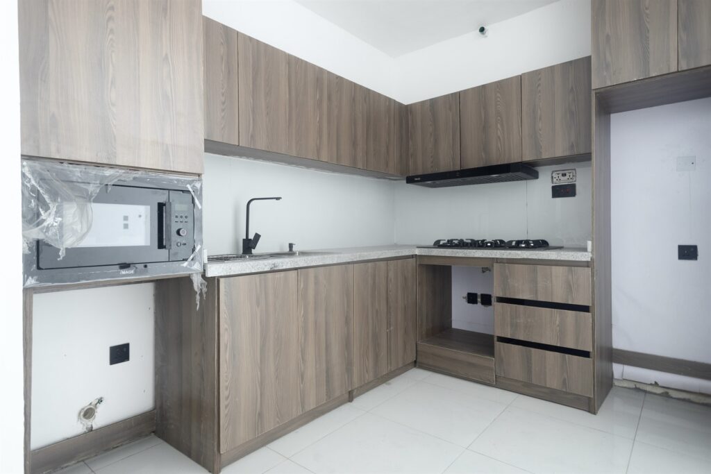 Brum Height 5: Kitchen sink and worktop beneath fitted wall cabinets